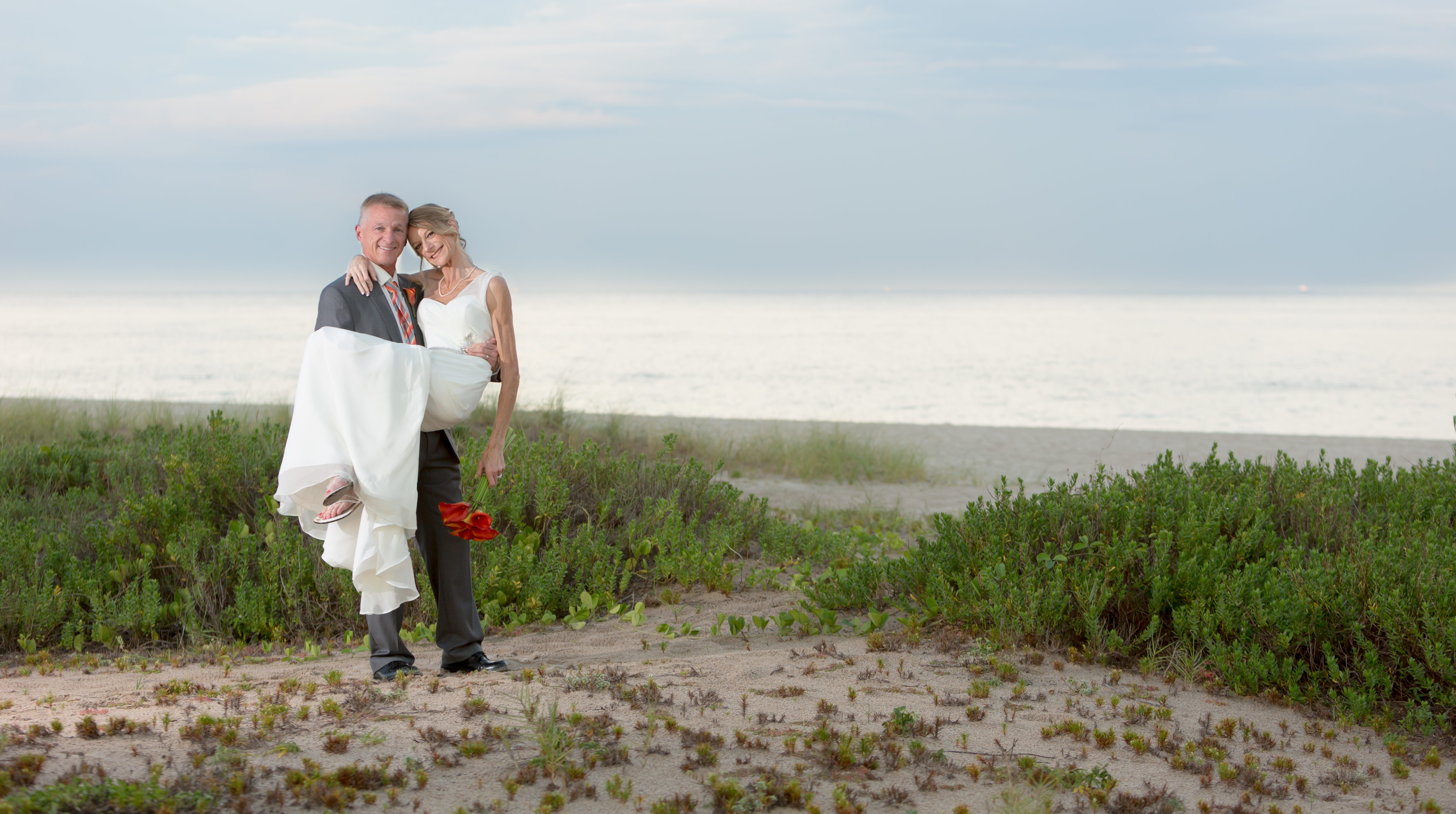 Wedding Portrait photo of the bride and groom on the beach behind the sea watch restaurant in lauderdale by the sea florida by the best fort lauderdale wedding photographer alfredo valentine couture bridal photography
