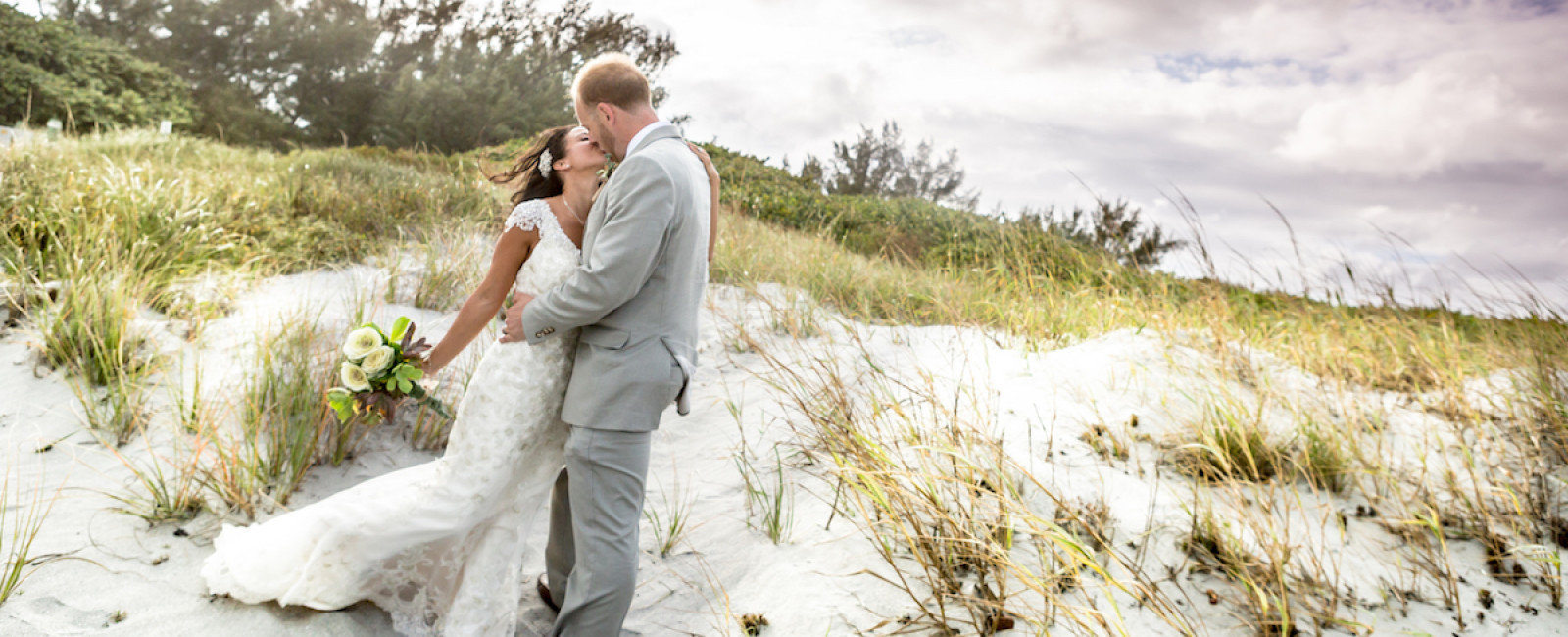 The best Miami Wedding Photographer in South Florida is Couture Bridal Photography. Image of Bride and groom in an embrace after a beach wedding ceremony