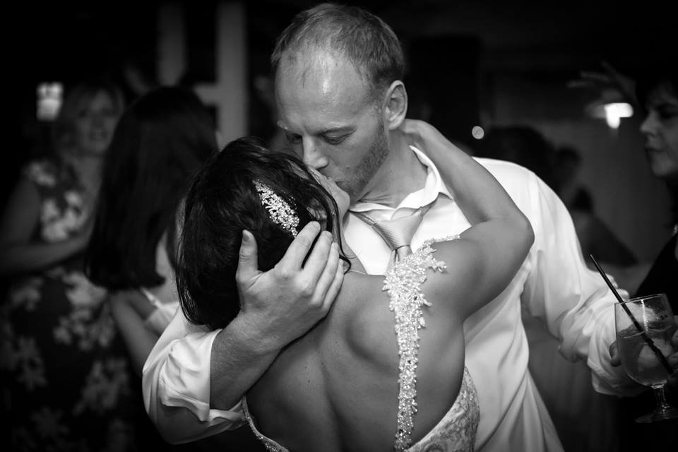 Finding South Florida Photographers for Engagement and Wedding Photography by Couture Bridal Photography South Florida Wedding Photographers. Image of bride and groom during their wedding reception dancing and a romantic kiss
