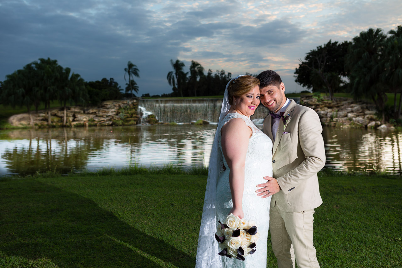 Couture Bridal Photography is a preferred Bonaventure Country Club wedding photography studio. Bride and groom in front of BonaVenture waterfall on golf course