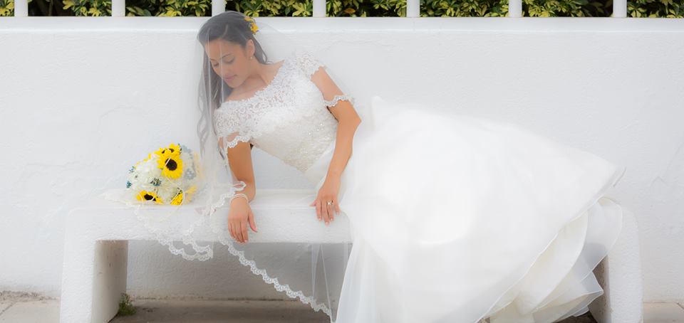 Couture Bridal Photography is a highly rated wedding photographer in Fort Lauderdale Florida serving south Florida and the caribbean. A bridal portrait of the the bride on a bench laying on her side during the cocktail hour at her Lakeside Terrace Wedding day Reception