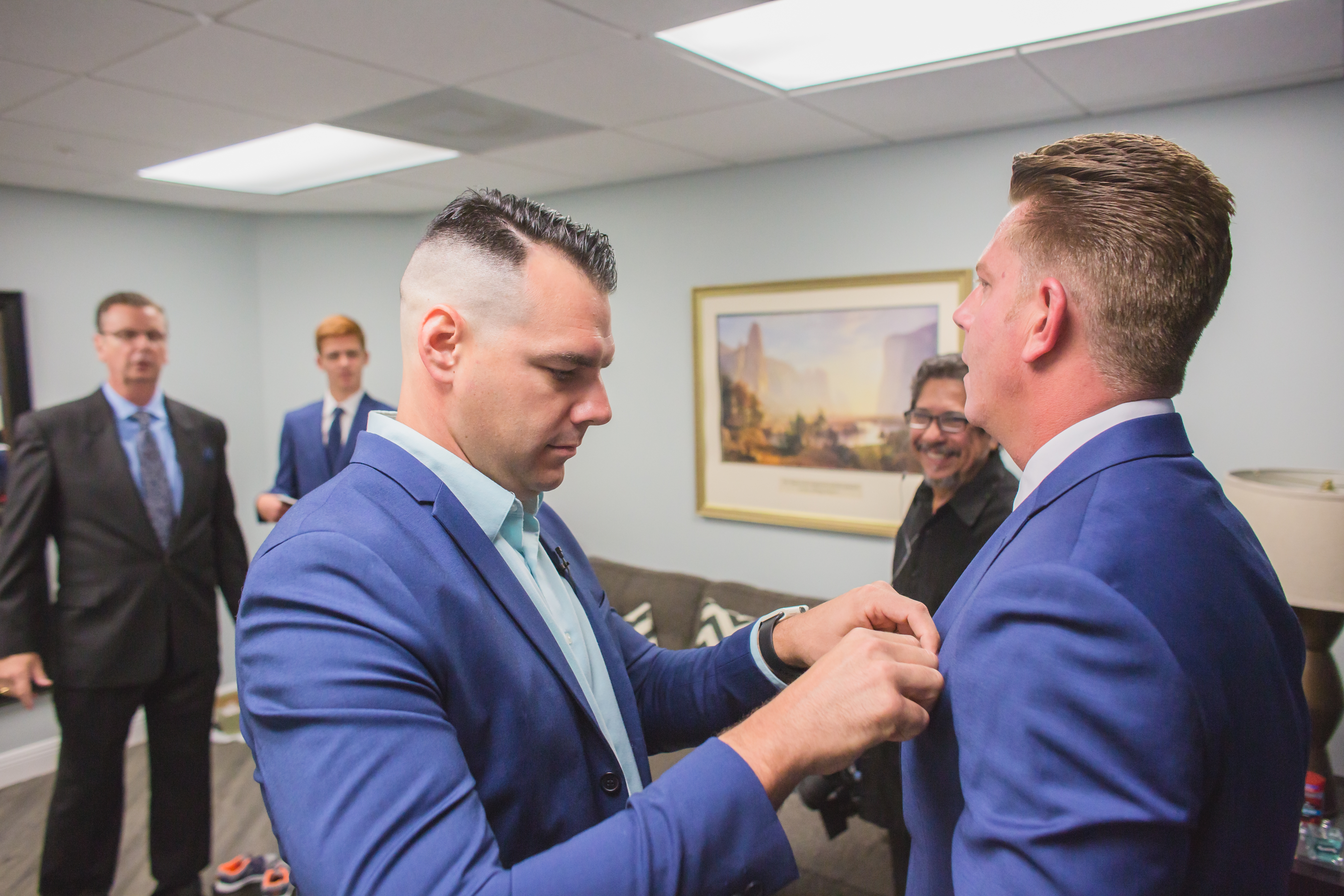 Groom getting a little help from the minister at Christ Fellowship church before his wedding captured with photojournalism