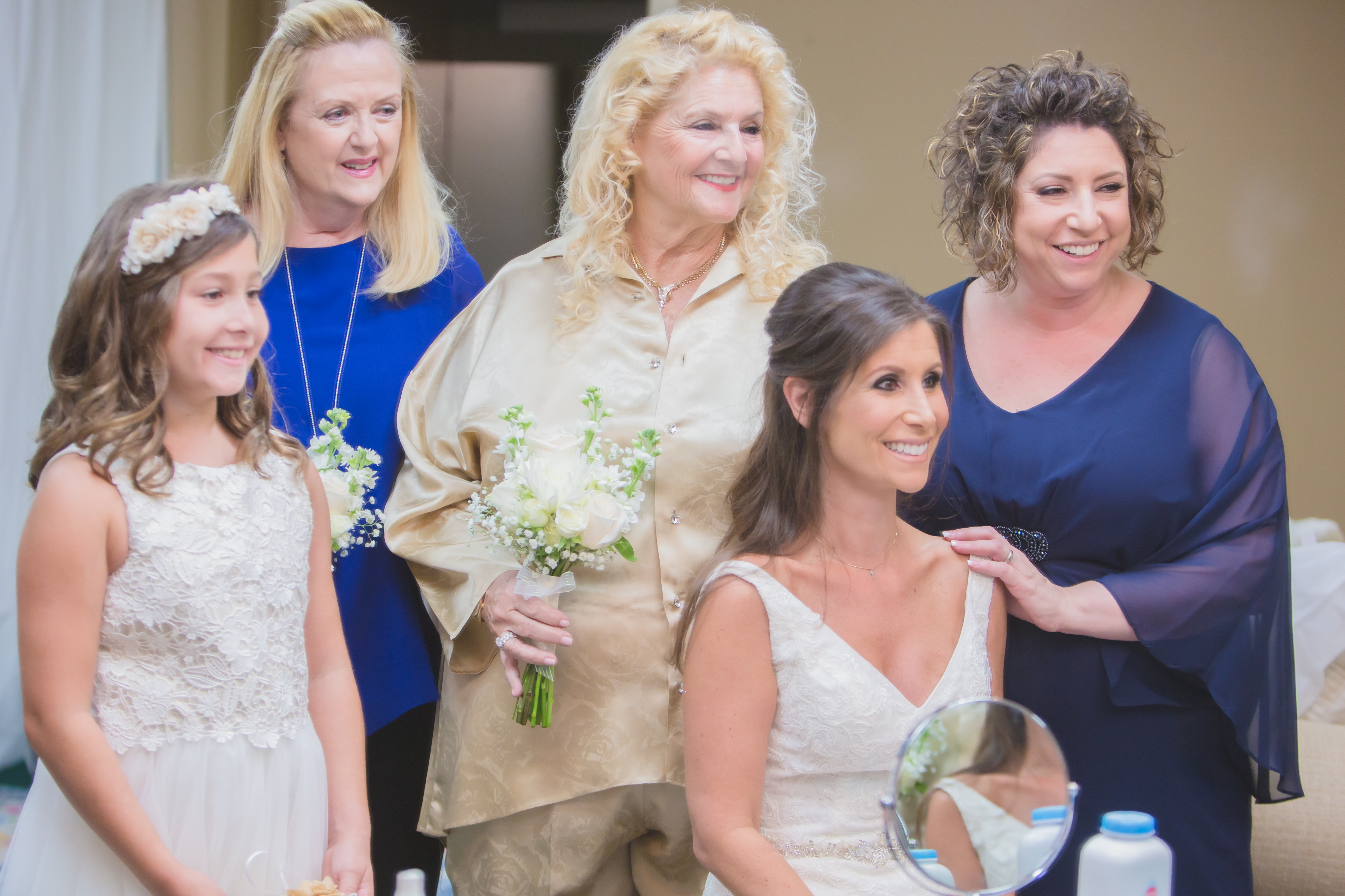 The bride with her sister mother daughter and mother in law right before the wedding ceremony is going to begin